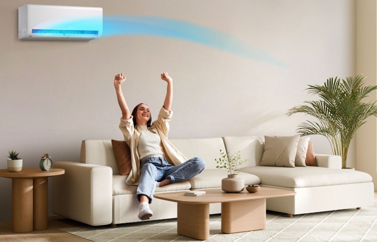 Klimatyzator TCL FreshIN 3.0 zamontowany na ścianie w salonie, z osobą cieszącą się świeżym powietrzem